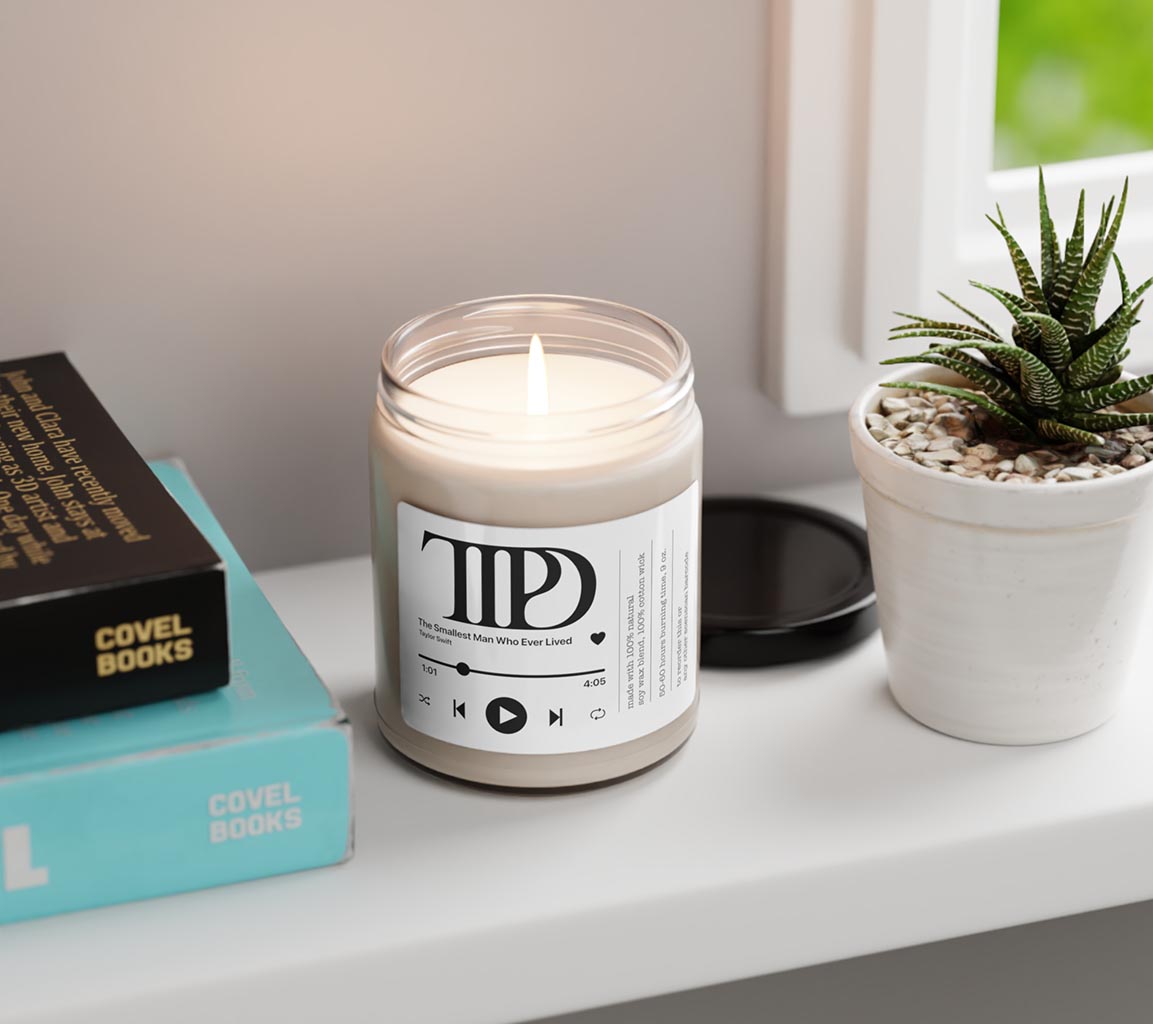 Taylor Swift Candle - The Smallest Man Who Ever Lived 9oz. Scented Candle. Available in clean cotton, Sea Sal + orchid, White Sage + Lavender, Apple Harvest, Cinamon Vanilla, Atlantis Whisper, Christmas Warmth, Coconut Cream + Cardamom, Peppered Passionfruit and Unscented Front View Top lit